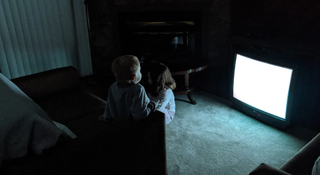 Skinamarink children sat in front of the TV