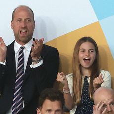 Prince William wears a suit with a red, white, and blue striped tie, and daughter Princess Charlotte wears a navy and white polka dot dress, as the pair attend the UEFA Women's Championship in Switzerland