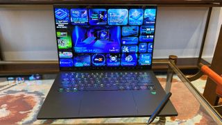 Acer Predator Triton 14 AI gaming laptop on a glass table.