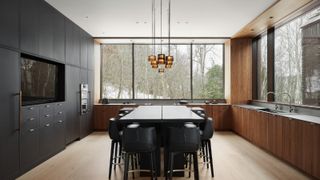 large kitchen with central island and seating, cluster pendant light with glass and metallic shades above island
