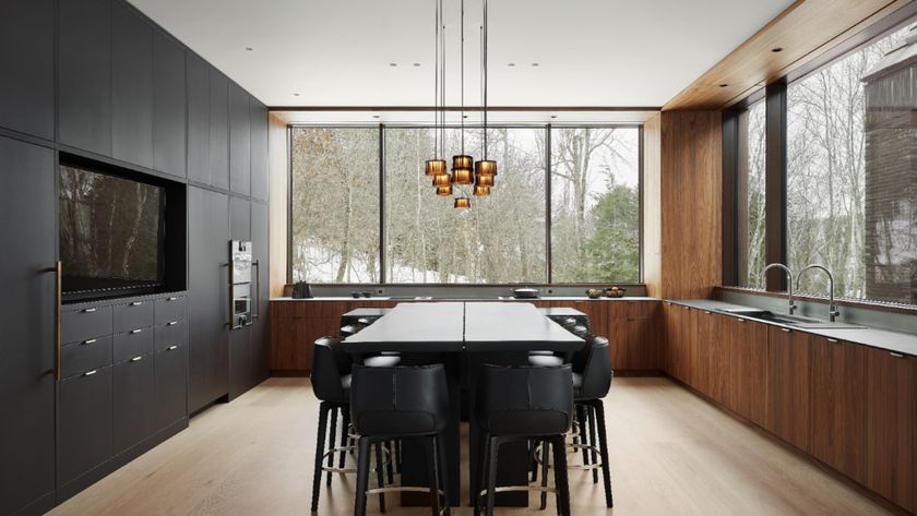 large kitchen with central island and seating, cluster pendant light with glass and metallic shades above island