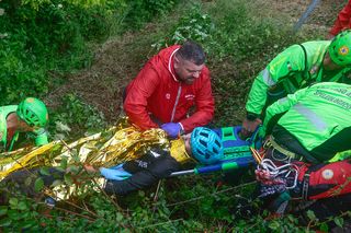 Alessio Martinelli is taken to an ambulance after sliding off the road and into a ravine during stage 16 of the Giro d'Italia