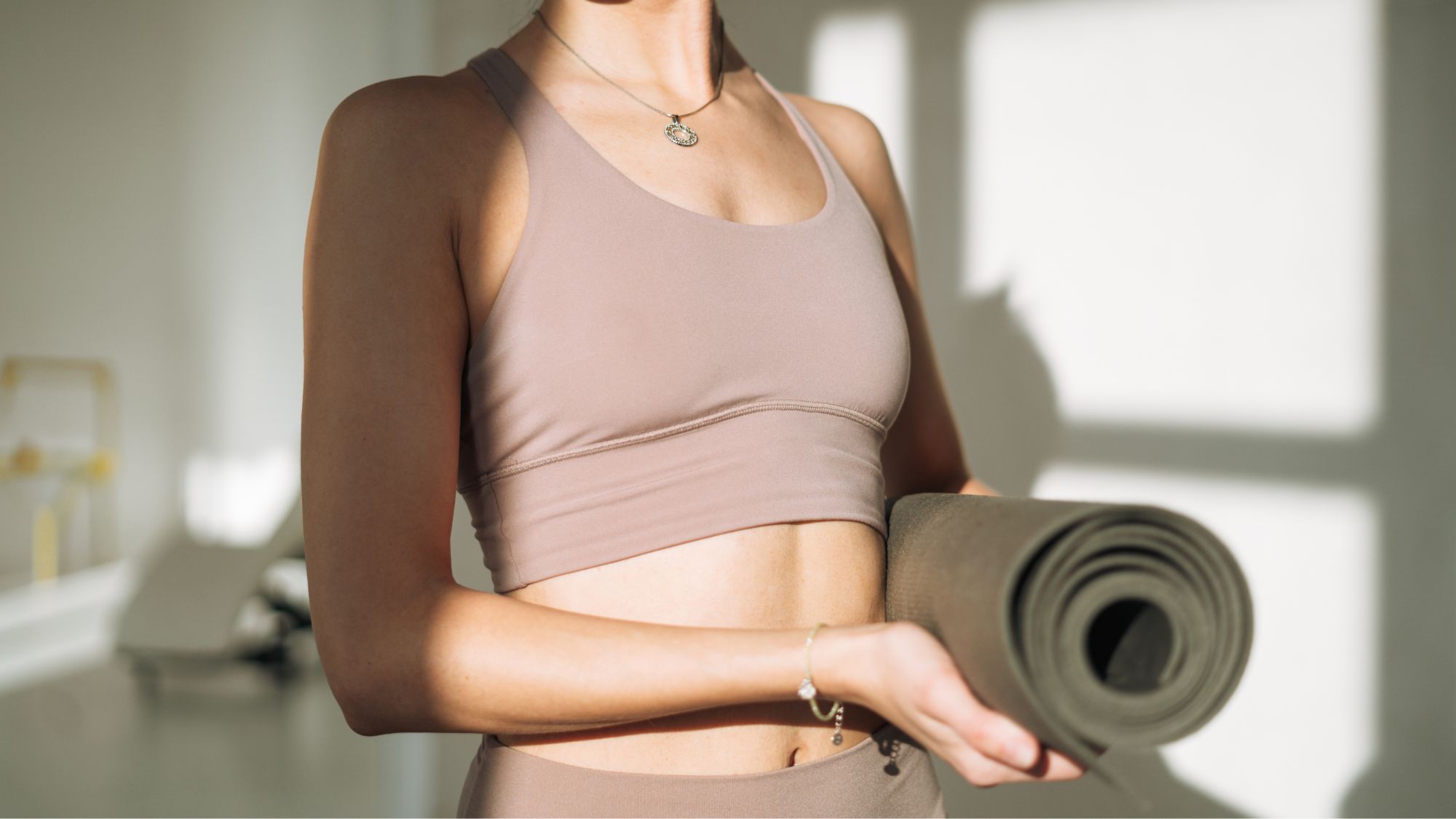 Woman holding a yoga mat