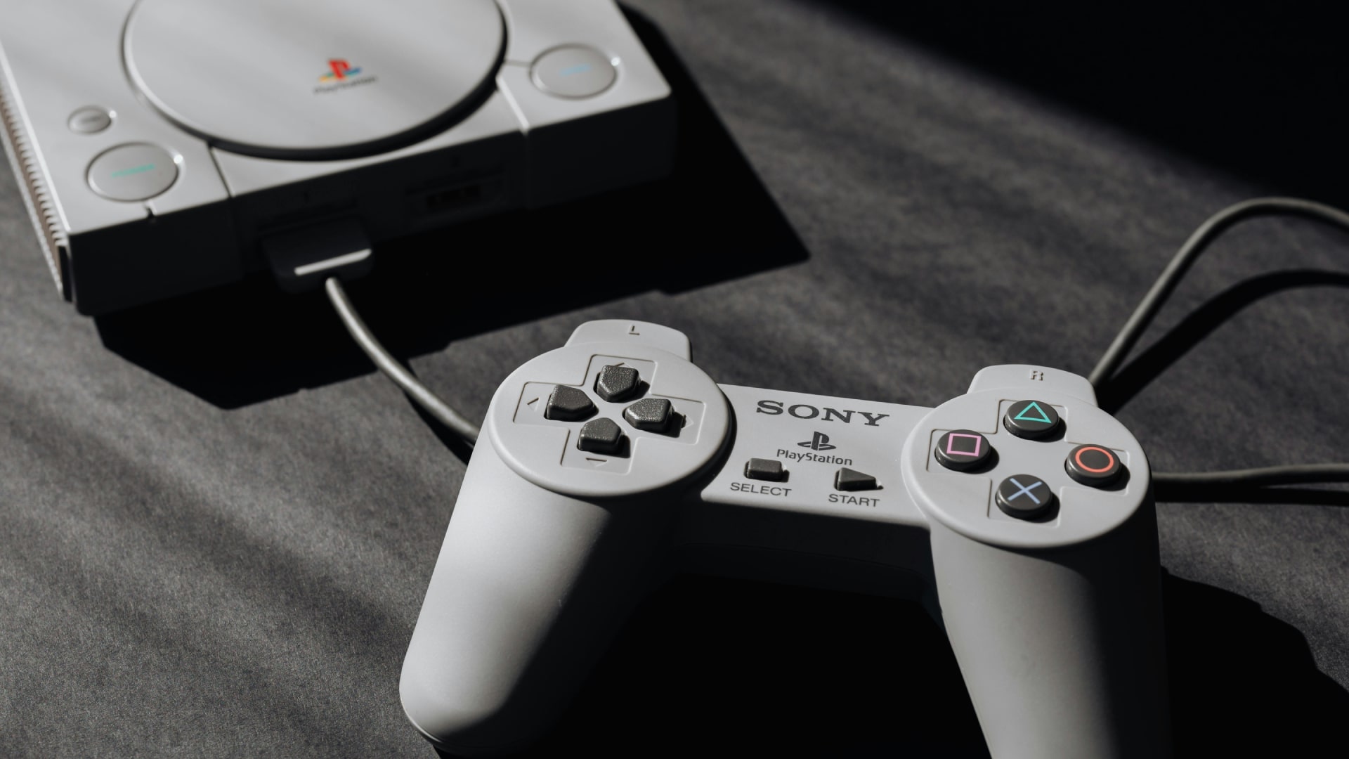 A Sony PlayStation 1 console and controller.