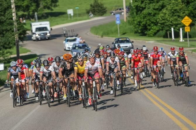 The mens peloton rolls in after a break goes up the road.