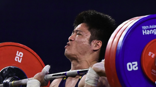 China's Fabin LI competes in the men's 61kg group A weightlifting ahead of the Weightlifting live stream at Olympics 2024