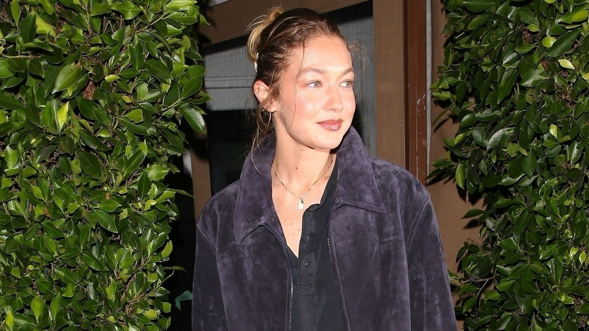 Gigi Hadid was spotted in L.A. wearing a suede jacket, a henley shirt, jeans, and brown loafers