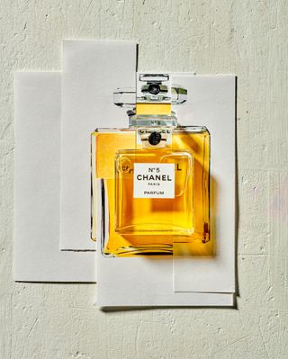 Chanel no.5 perfume bottle against cut out images of chanel no.5 bottles from the past