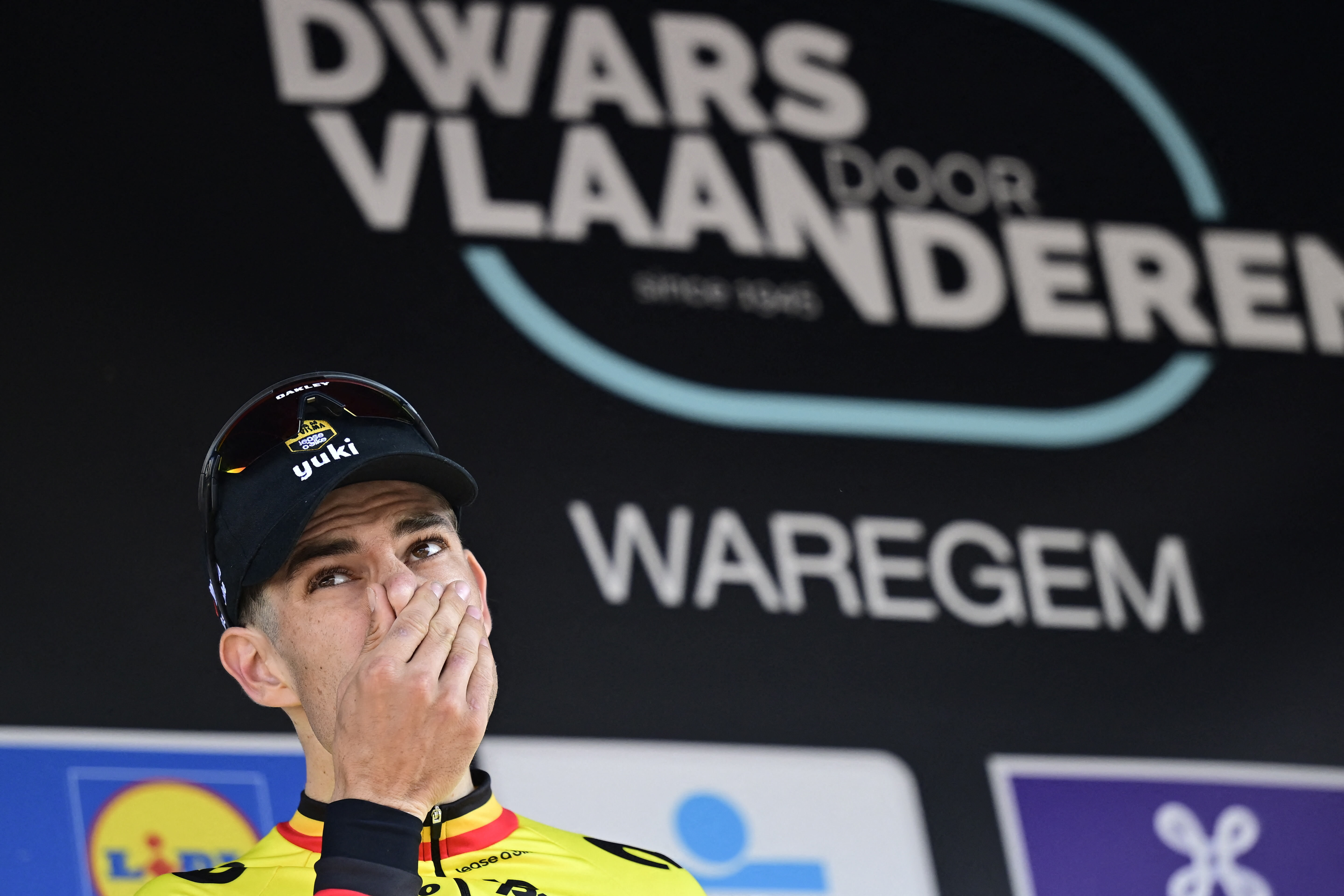 Team Visma-Lease a Bike's Belgian rider Wout van Aert reacts on the podium of the men's elite race 'Dwars Door Vlaanderen', 184,2 km from Roeselare to Waregem, on April 2, 2025. (Photo by DIRK WAEM / Belga / AFP) / Belgium OUT