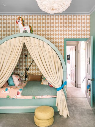 kids room with covered bed and harlequin wallpaper
