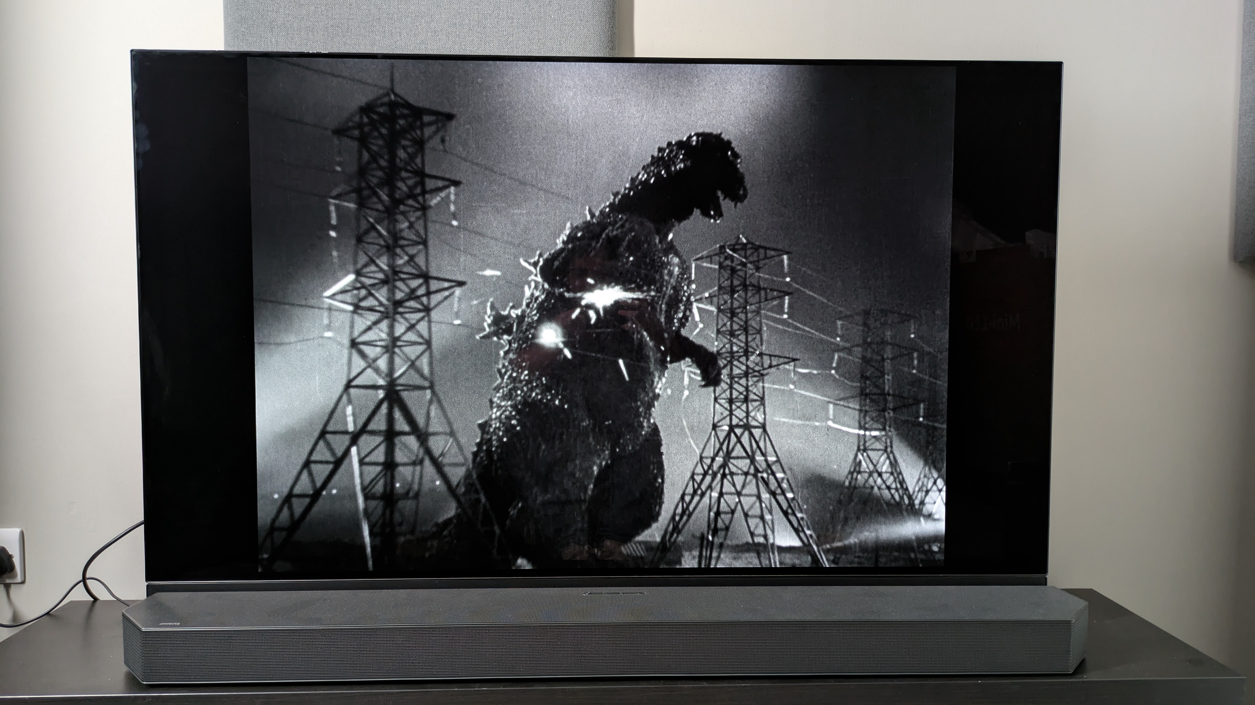 Godzilla (1954) image of Godzilla on Panasonic MZ1500 OLED with HW-Q990C soundbar in front of TV