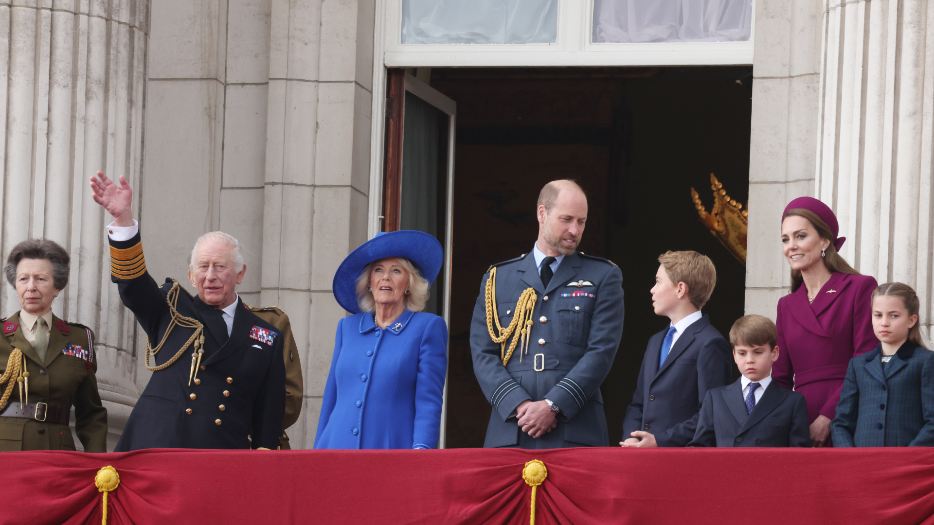 Queen Camilla, Prince William, Princess Kate, Prince George, Prince Louis and Princess Charlotte standing on the balcony of Buckingham Palace