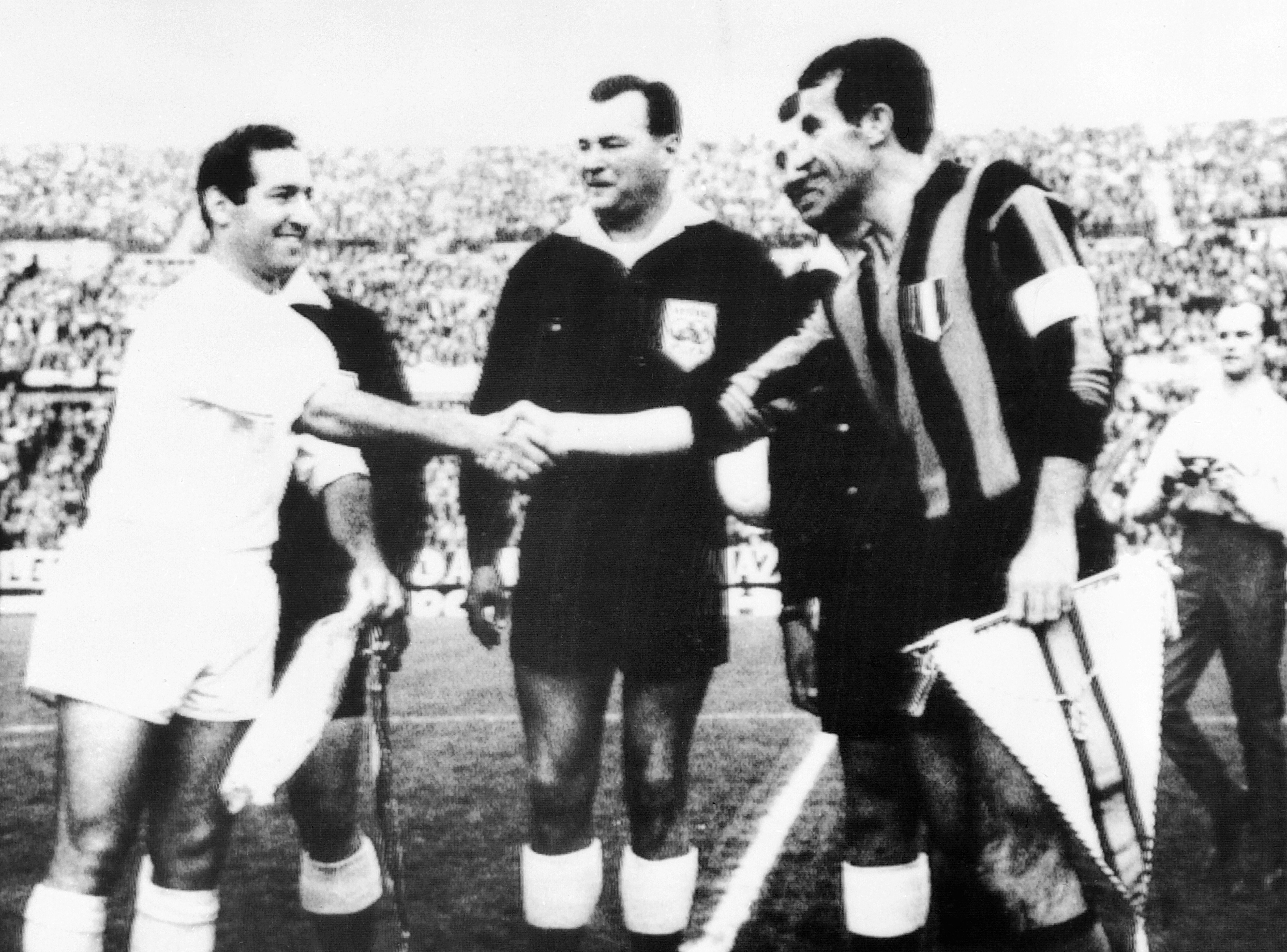 Real Madrid's Francisco Gento and Inter's Armando Picchi shake hands ahead of the 1964 European Cup final.