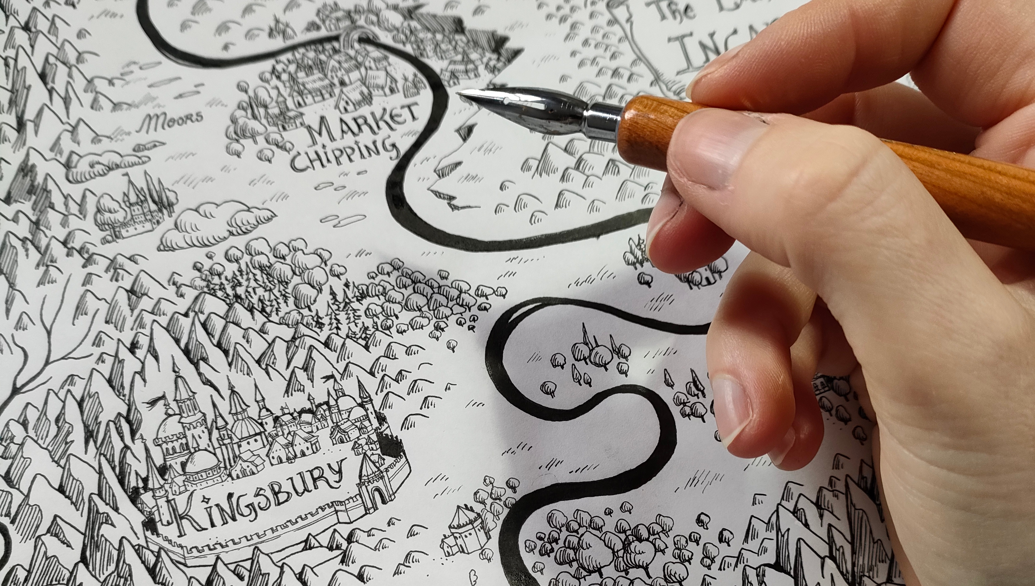 Artist in residence; a close-up of an artist using an ink pen