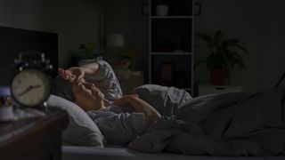 Woman laying awake in bed at 2.40am