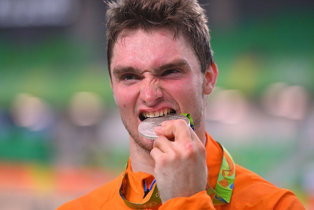 Matthijs Buchli (Netherlands) takes a bite out of his silver medal