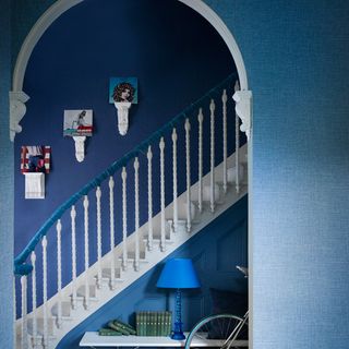 indigo hallway with blue and white staircase