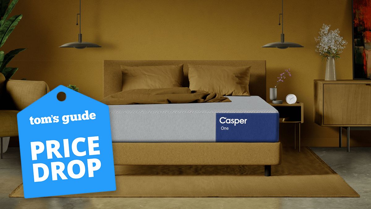 The Casper One mattress on a bed frame in a room with a Toms&#039; Guide sale graphic overlaid on the image