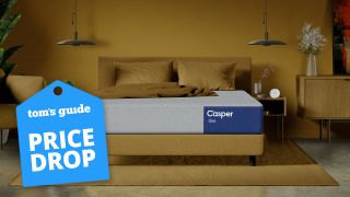 The Casper One mattress on a bed frame in a room with a Toms' Guide sale graphic overlaid on the image