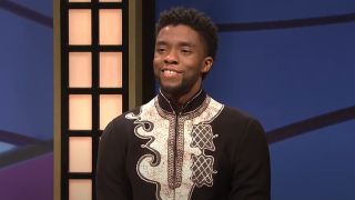 Chadwick Boseman smiling as T'Challa on Black Jeopardy in an episode of SNL.