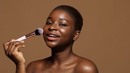 woman applying blusher