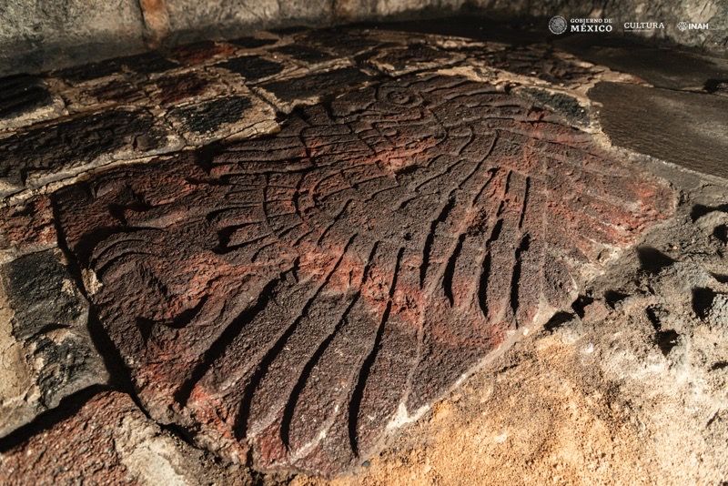 A bas-relief of a golden eagle carved into the floor near the famous Aztec site Templo Mayor