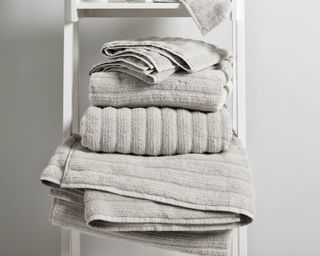 The White Company Hydrocotton Towels, grey, folded on bathroom shelving