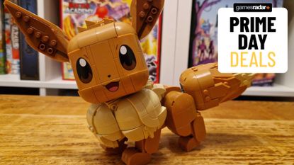 Lego Eevee set on a wooden table, behind a GamesRadar+ Prime Day deals badge