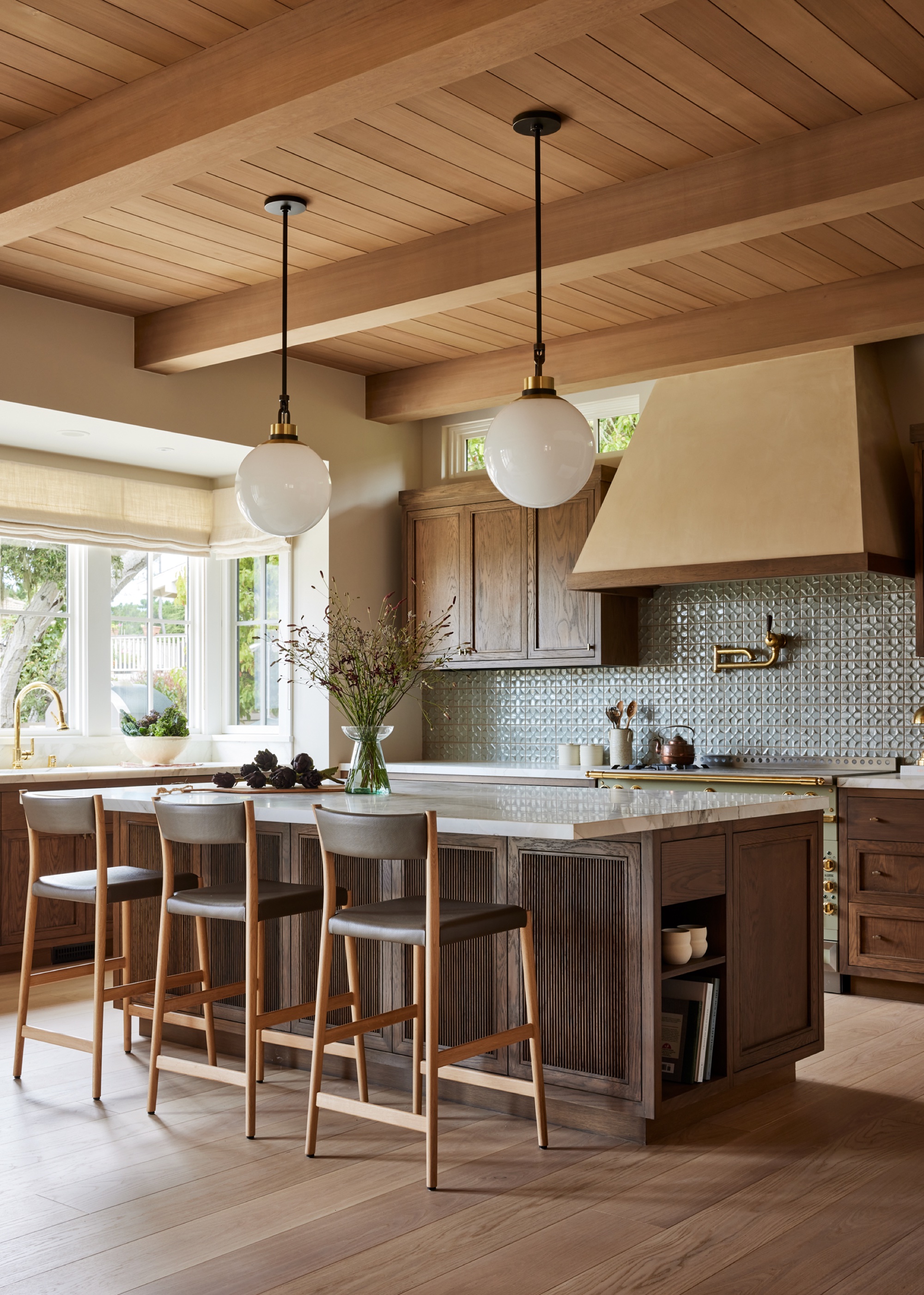 wood kitchen with wooden ceiling and glass orb pendants by Kristen Pena Interiors