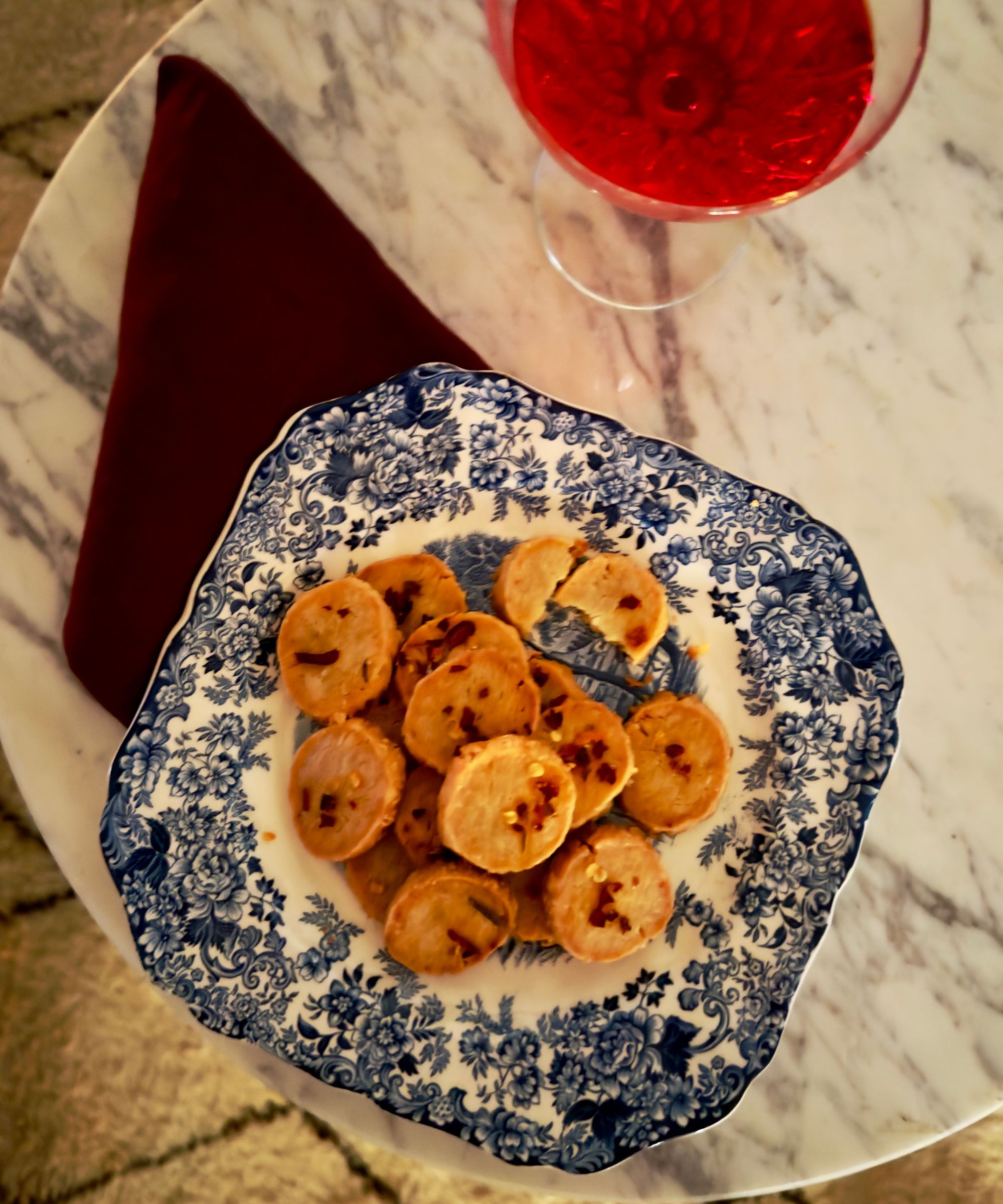 Cheese biscuits on a blue and white plate on a marble table