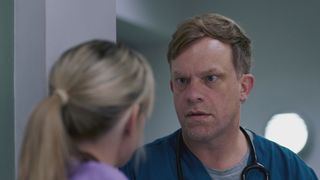 Dylan Keogh looks shocked as he talks to Sophia Peters in Casualty. 