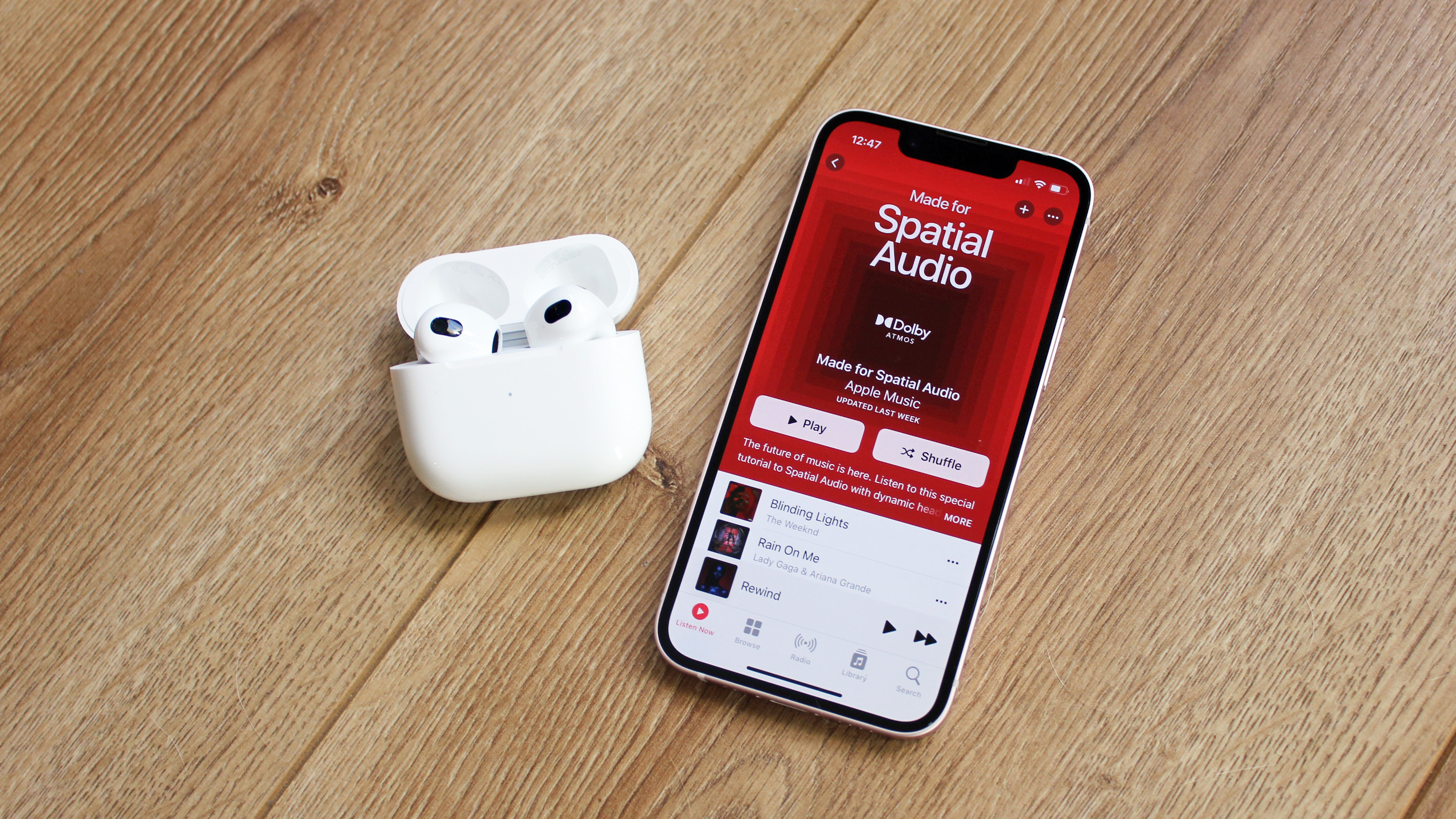 the airpods 3 with an iphone 13 mini displaying spatial audio on apple music