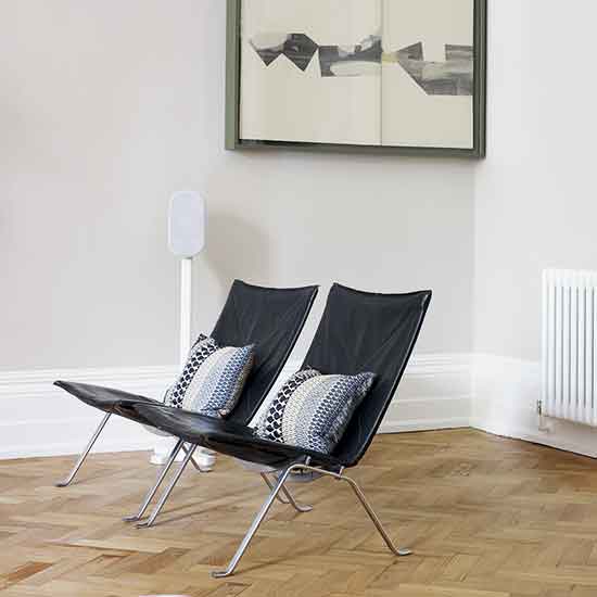 white wall with relaxing chairs and cushions