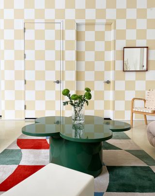 a checkerboard wall with painted doors