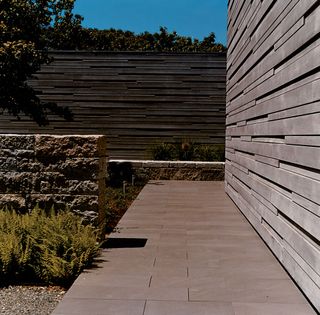 Courtyard showing wooden walls and paving and stone wall in Martha's Vineyard