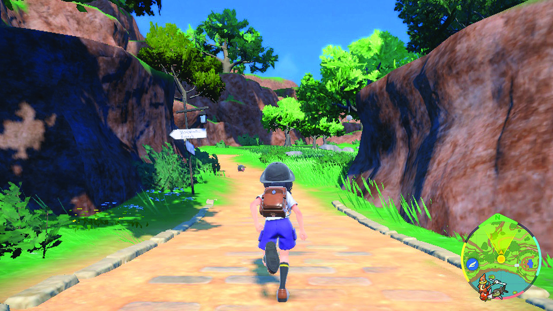 The player runs through a green valley - from Pokemon Scarlet and Violet's entry in The Story of Pokemon bookazine