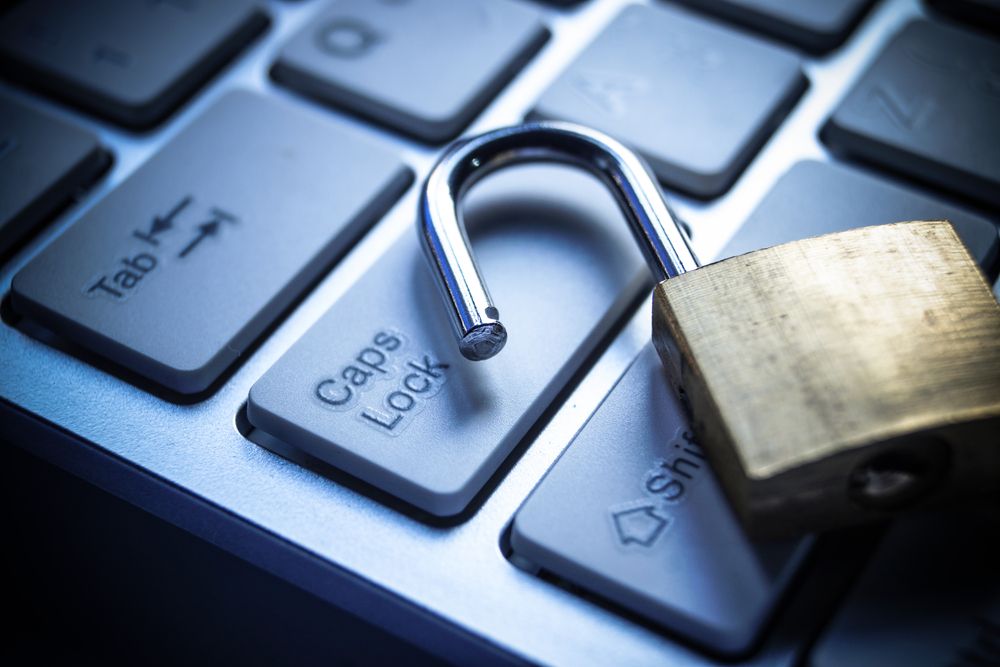 Image of an unlocked padlock casually discarded onto on a keyboard