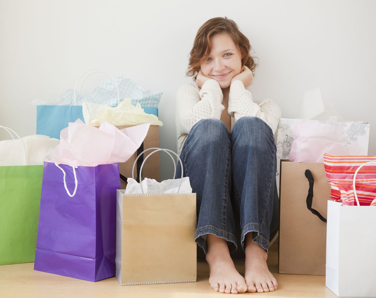 Teenage girl surrounded by shopping bags