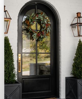 black front door with Christmas wreath