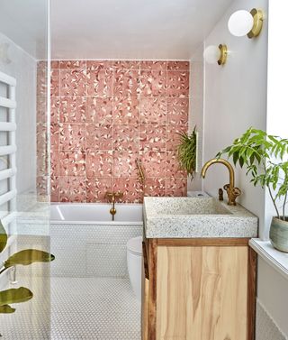 bathroom with pink mosaic wall tiles