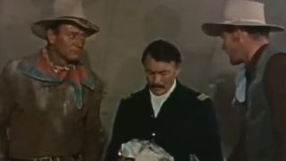 John Wayne talking to two other men in Hondo