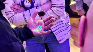 Humane AI Pin laser UI being projected onto a person's hand