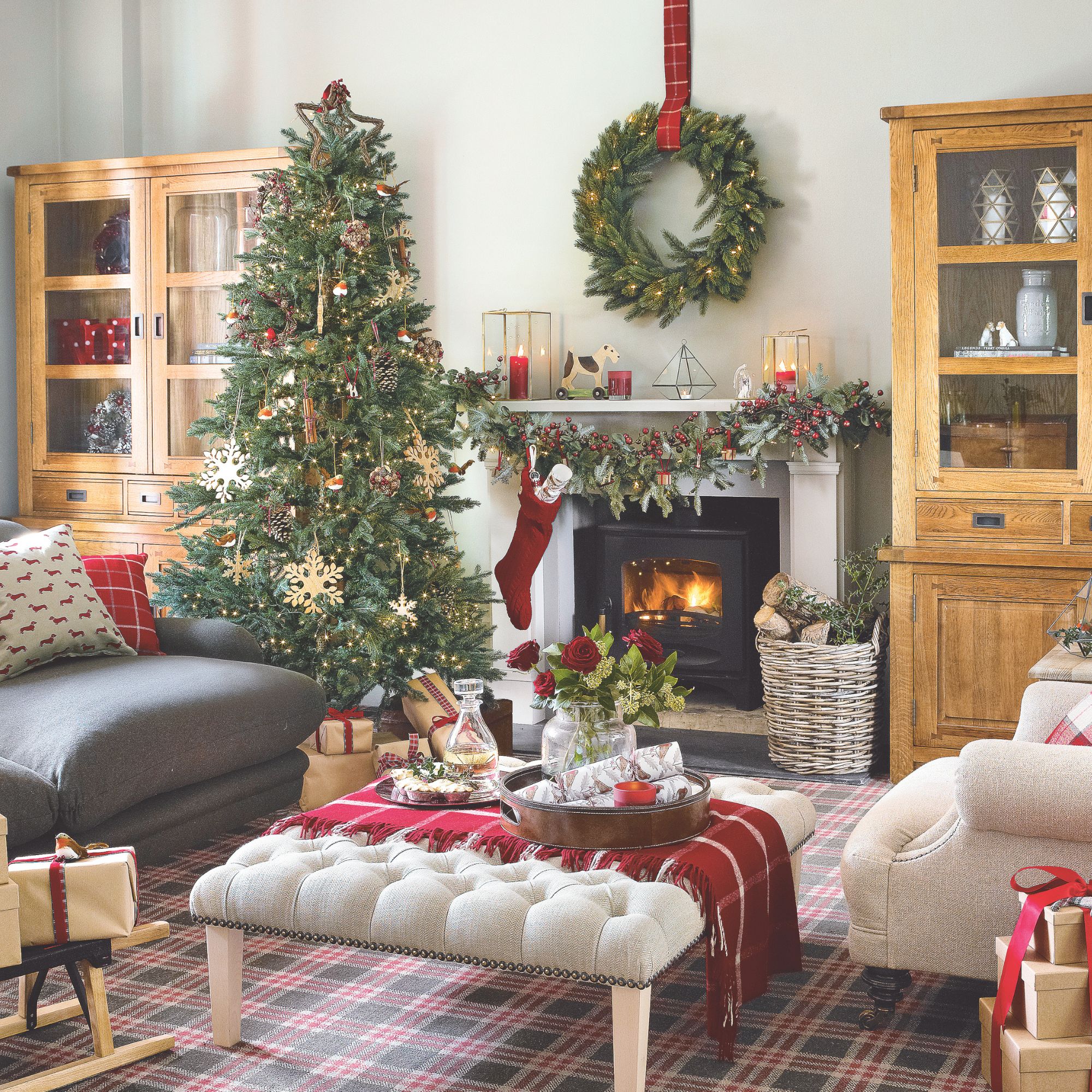 A traditional red and green Christmas scheme with white accents and a fireplace