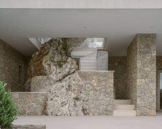 Corfu House minimalist interior and stone exterior with swimming pool looking to the sea