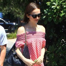 Maude Apatow wearing a Frankies Bikinis red gingham dress and red Mary Janes