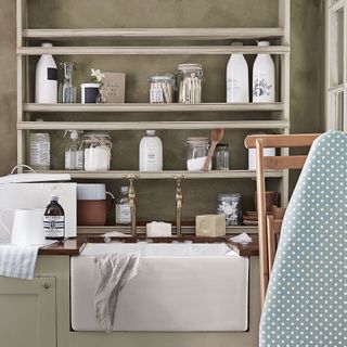 washing area with glass jars on wooden shelves