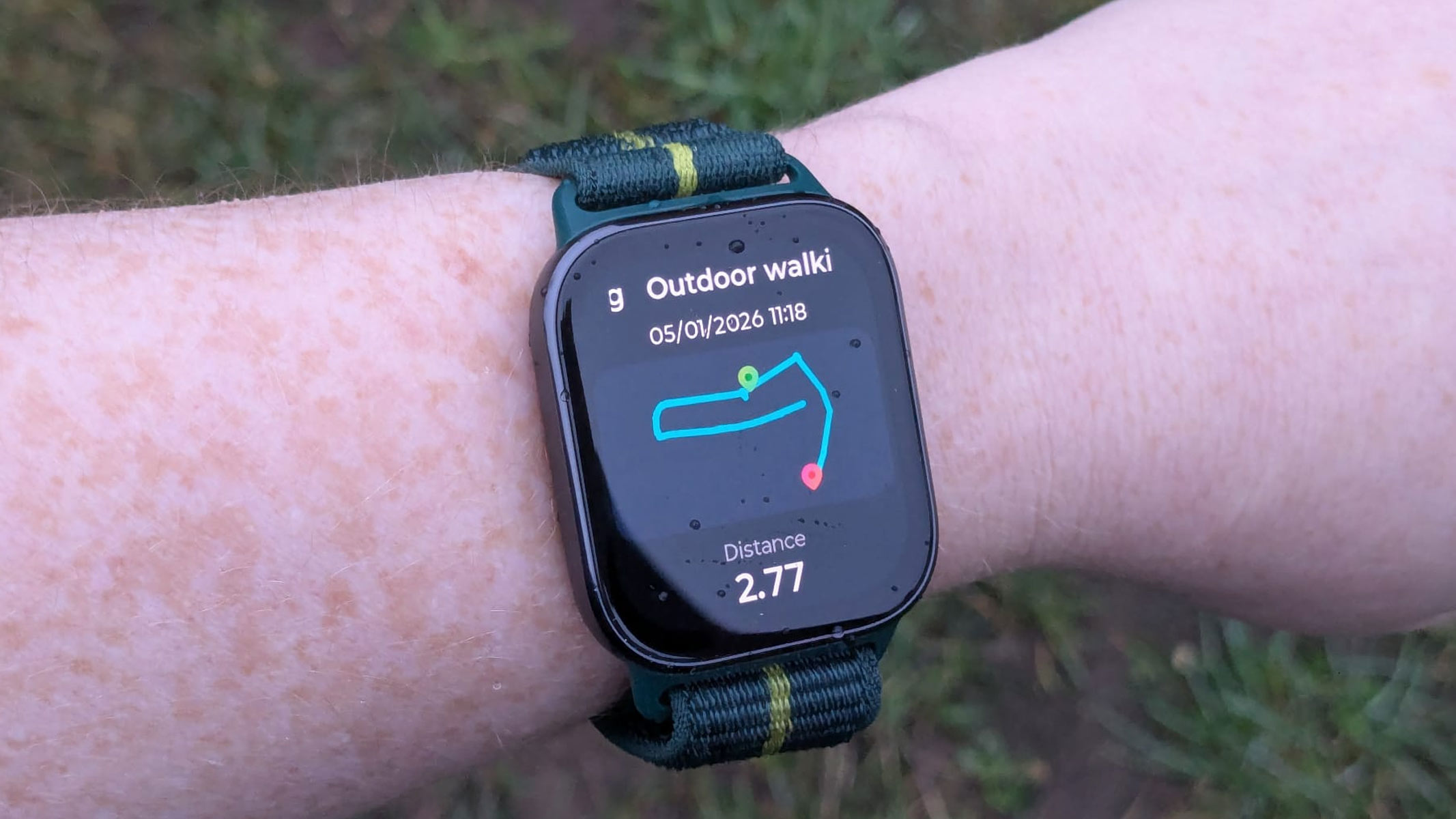 Our reviewer wearing the Motorola Moto Watch Fit outside, capturing the walking stats after a walk