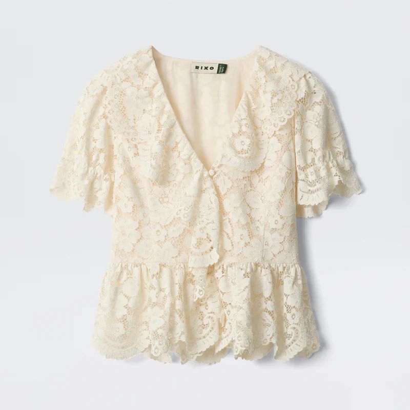 A cutout of an ivory lace blouse by Rixo