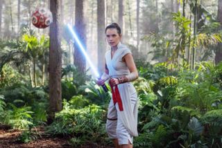 Daisy Ridley with a light sabre