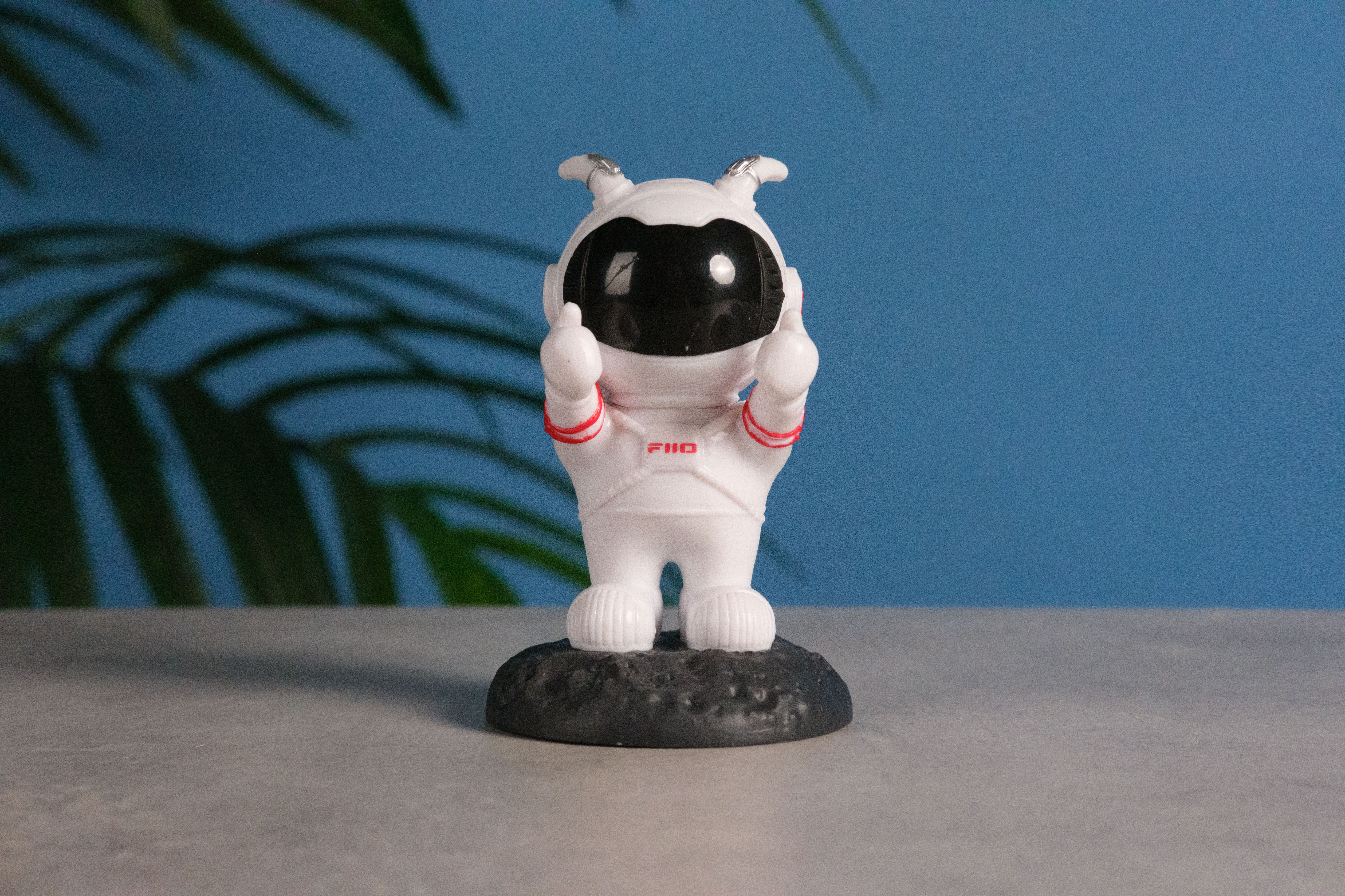 A photo of an astronaut toy against a blue background, taken on the Fujifilm X-E5